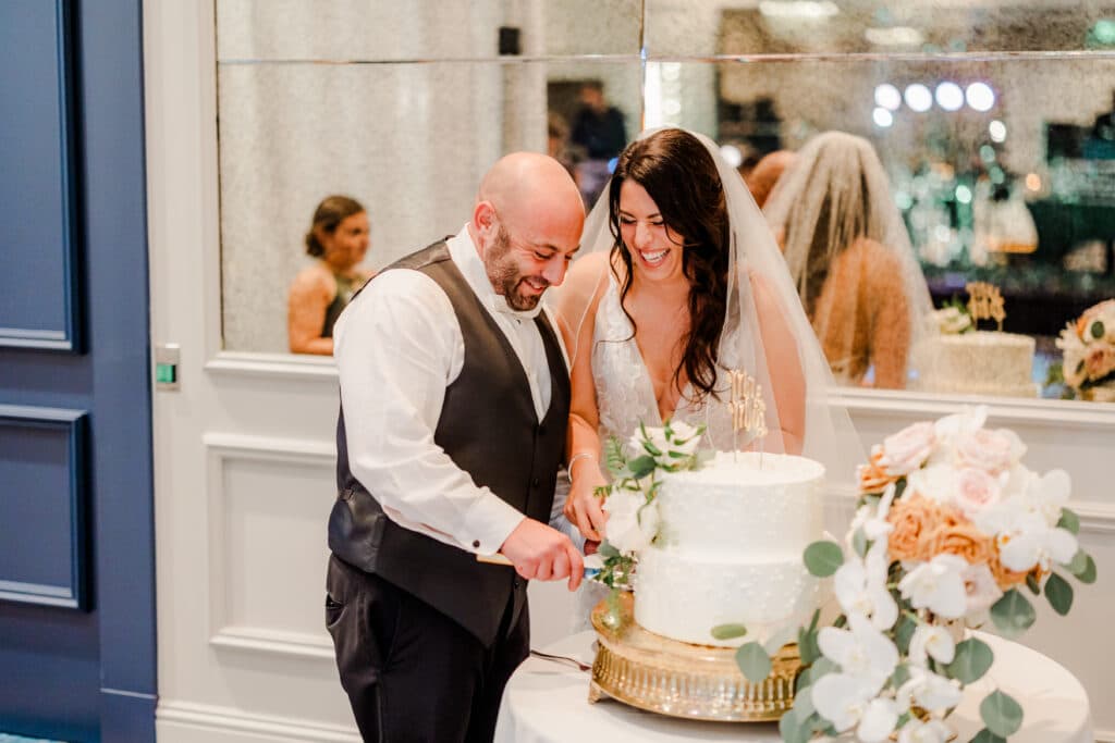 Bride and groom cutting cake for Wedding/event space at JW Marriott Plant Riverside District Savannah