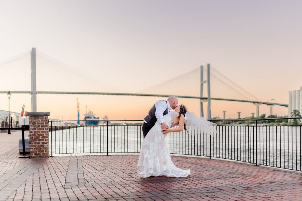 Couple on the riverwalk with the Talmadge Bridge at JW Marriott Plant Riverside District Savannah